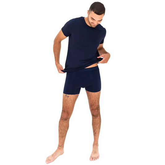 man wearing ink blue boxer briefs and ink blue lawrence crew tee front view set on a white background