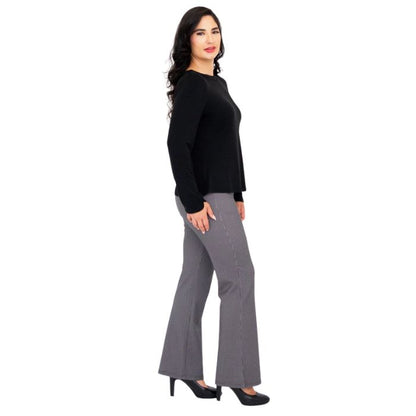 female model wearing mona black long sleeve top and daya pants side view on white background