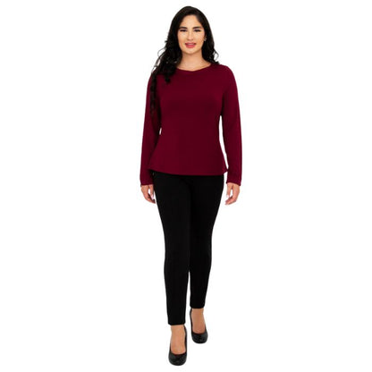 female model wearing mona burgundy red long sleeve top and nadia black pants front view on white background