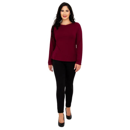 female model wearing mona burgundy red long sleeve top and nadia black pants front view on white background