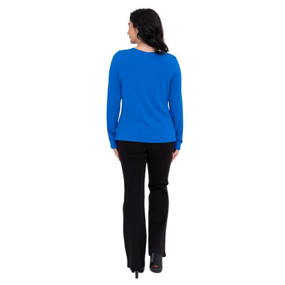 female model wearing mona cobalt blue long sleeve top and daya black pants front view on white background