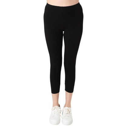 female model wearing black suri capri length leggings front view on white background 