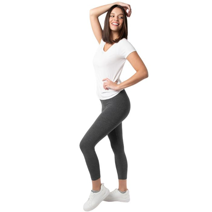 female model wearing charcoal grey suri capro leggings and white brenda tee side view on white background