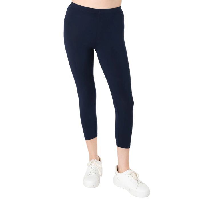 female model wearing ink blue suri capri length leggings front view on white background 