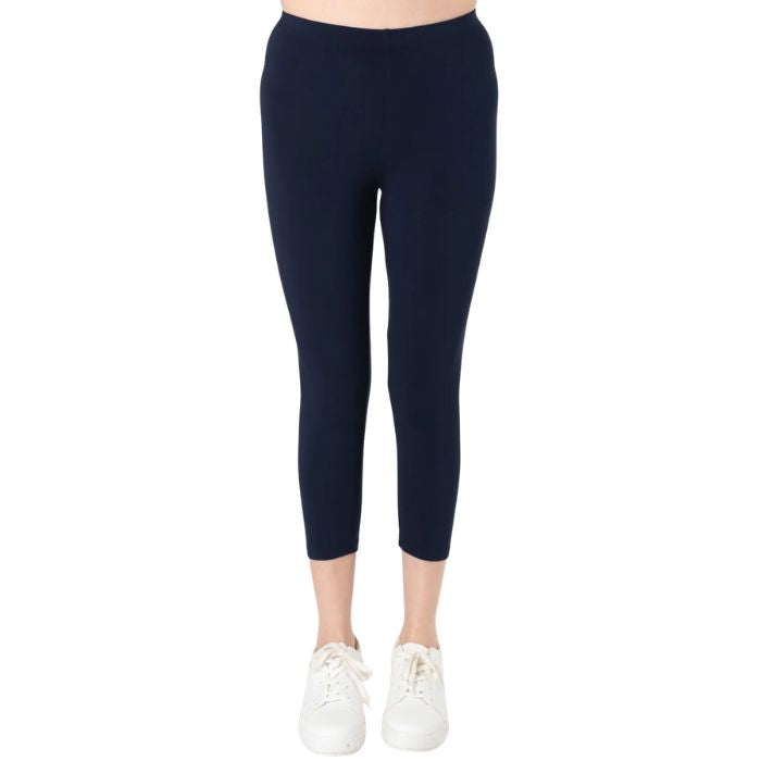 female model wearing ink blue suri capri length leggings front view on white background 