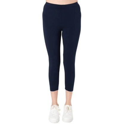 female model wearing ink blue suri capri length leggings front view on white background 
