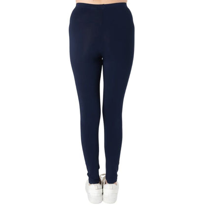 female model wearing ink blue suri full length leggings back view on white background 