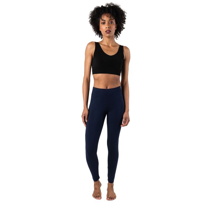 female model wearing ink blue suri full length leggings and black terrera essential bralette front view on white background 