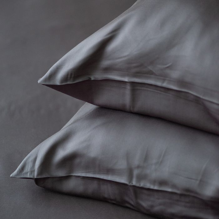 charcoal grey terrera two bamboo pillowcases on pillows stacked on bed