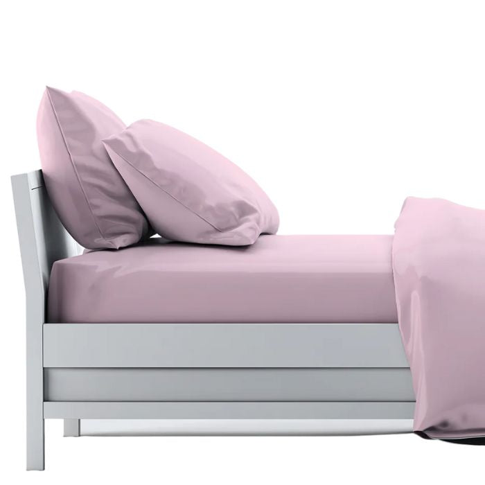 Pale rose pink sheet set- flat sheet, fitted sheet and two pillowcases on made bed