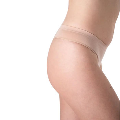 female model wearing beige thong underwear side view on white background